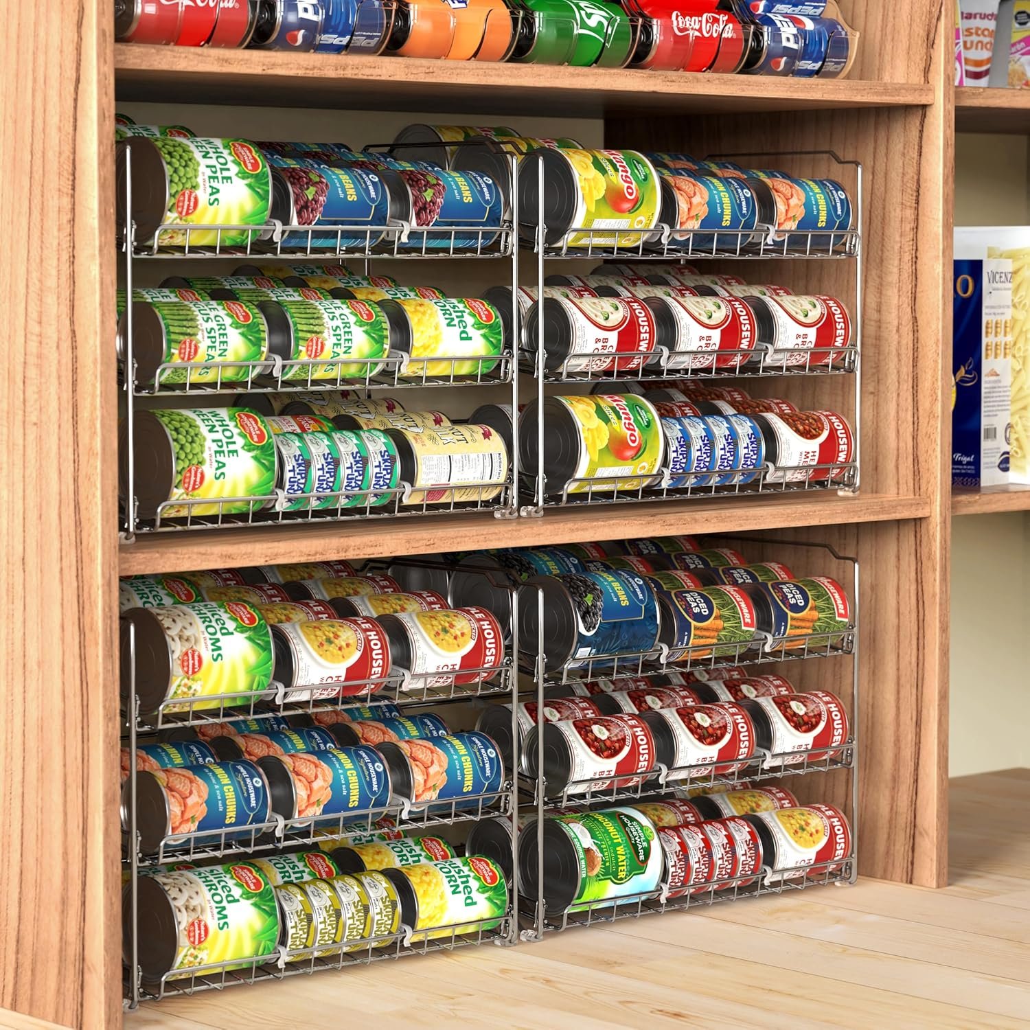 Cans rolling forward on the stepped tiers of the can organizer rack